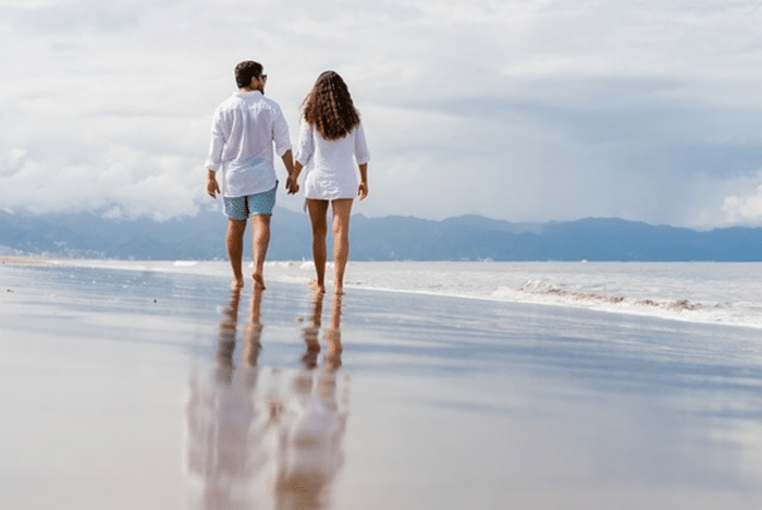 Couple on beach walking and talking